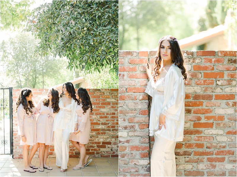 Bride poses in courtyard with her sisters.