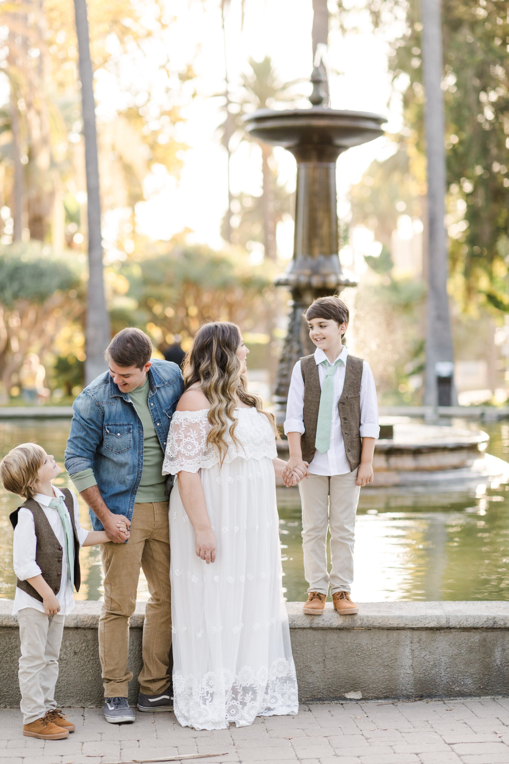 Family poses near fountain during golden hour in Beverly Hills, CA