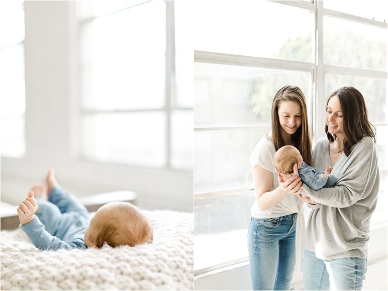 Lesbian Mothers hold their baby boy during their newborn photo session taken in a natural light studio in downtown Los Angeles.  Newborn photography near me.