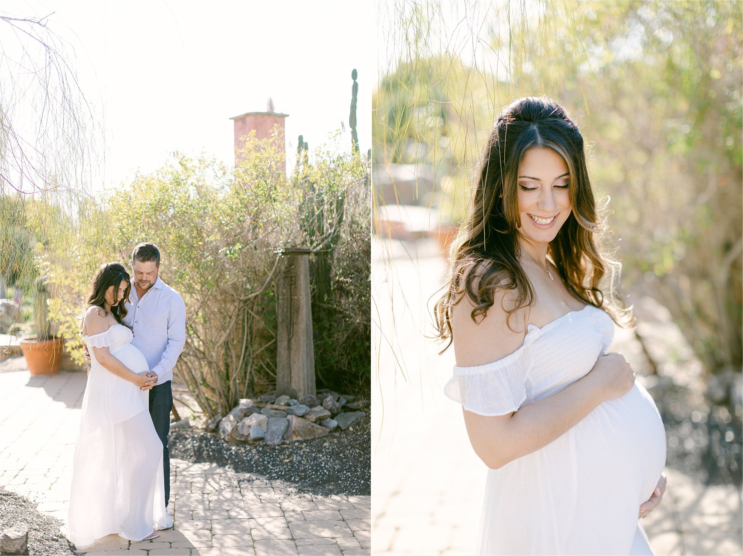 Beautiful brunette woman in white flowy dress with flutter sleeves holds her belly surrounded by dreamy natural light during her maternity photo session.