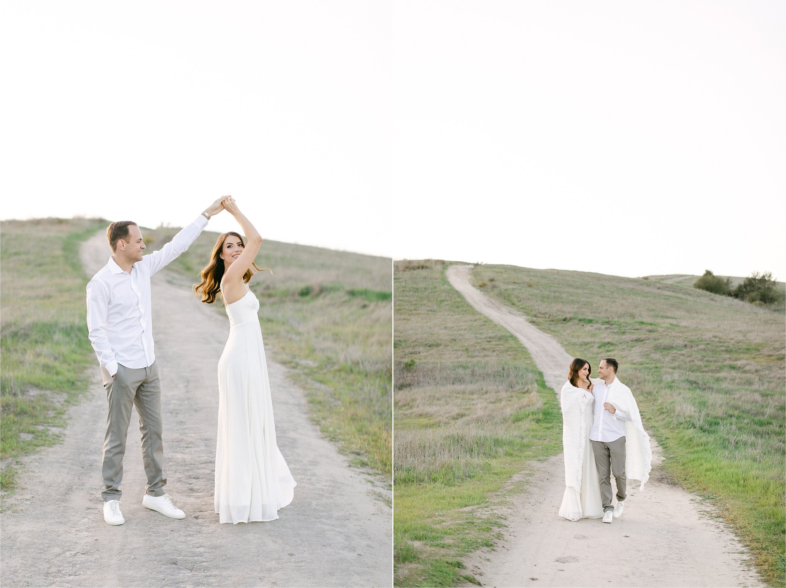 A Brunette man wearing grey pants and a white button down twirls his fiance wearing white chiffon dress during their Orange County engagement photography session.