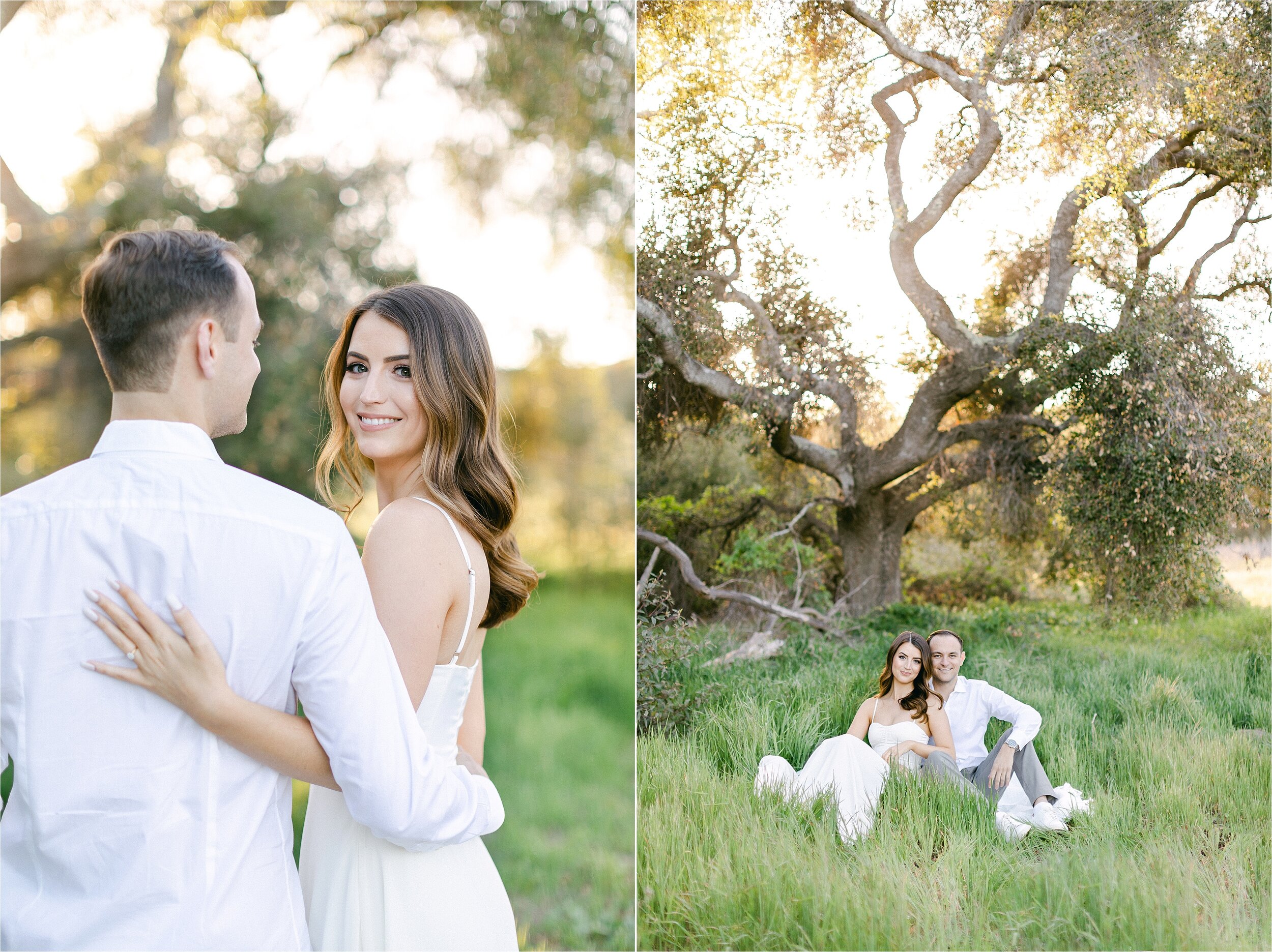 Brunette fiances, wearing a white chiffon dress and grey pants with a white button down, sit in a field of tall grass under an oak tree during their romantic engagement photography session. in Orange County, CA.