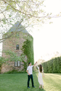 Image on the left shows groom-to-be give his bride-to-be a twirl on the lush green lawn, in front of the beautiful Dovecote. Image on the left shows the fiance's sharing a kiss under a tree-lined dirt road during their outdoor engagement session. Images taken by Santa Ynez Wedding Photographer, Tiffany J Photography.
