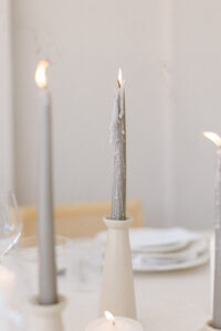 Detail photo of the taupe candles in ceramic candlesticks, featured on the editorial wedding reception tables-cape. 