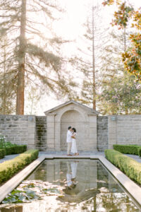 Brunette fiances snuggle into each other during their engagement photo session at Greystone Mansion in Beverly Hills, CA.