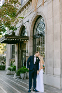 Bride and Groom share a kiss in front of the Culver Hotel following their micro wedding.