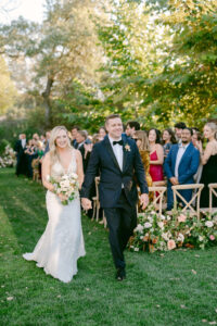 Bride and groom excitedly exit their wedding ceremony after becoming husband and wife.