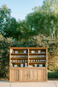 Detail photo showing the custom escort display with mini bottles of olive oil with guest's name and table number. 