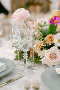 Reception details - etched glassware, light blue plates, stunning florals and gold flatware.