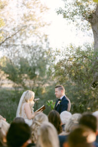 Bride recites her vows to her soon-to-be husband during their lakeside wedding ceremony at Greengate Ranch in San Luis Obispo.