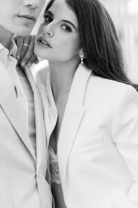 Black and white, cropped editorial, fashion forward image of bride and groom