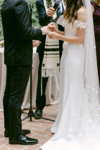 Bride and groom exchange rings during their Jewish wedding ceremony at Calamigos Ranch in Malibu, CA.