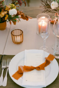 Rust colored ribbon ties menu to napkin to beautifully accent the fall decor at this Calamigos Ranch Wedding.