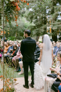 Bride circles her groom during their fall, Jewish wedding ceremony at Calamigos Ranch in Malibu.