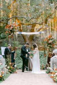 Groom stomps the glass following their pronouncement as husband and wife during their Jewish wedding ceremony.