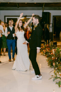 Bride and groom dance together as they celebrate with their guests.