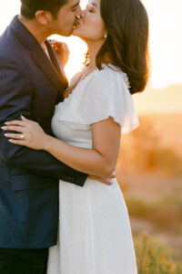 Fiance's share a kiss at sunset following his marriage proposal.