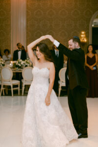 Groom twirls his bride during their first dance as husband and wife.
