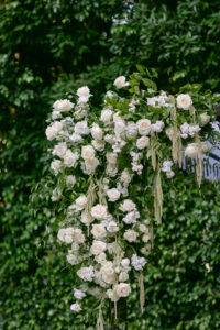 Close up of the white floral details on the wedding chuppah. 