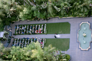 Epic aerial photo of bride being escorted down the aisle by her parents during her wedding ceremony at the Four Seasons Beverly Hills.