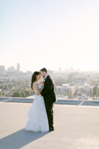 Bride and groom share a sweet dance during rooftop sunset photos at the Four Seasons Beverly Hills. Photographed by SoCal wedding photographer Tiffany J Photography.