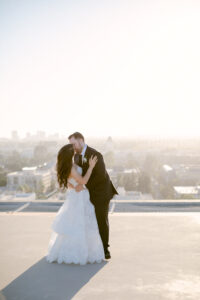 Bride and groom share a kiss on the rooftop of the Four Seasons Beverly Hills at sunset.