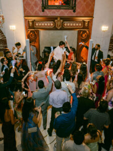 Wedding reception club energy as groom DJ's a set.